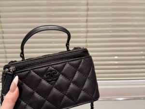 Chanel Classic Lambskin Vanity Bag with Top Handle in black leather, featuring black hardware and iconic Chanel CC logo.