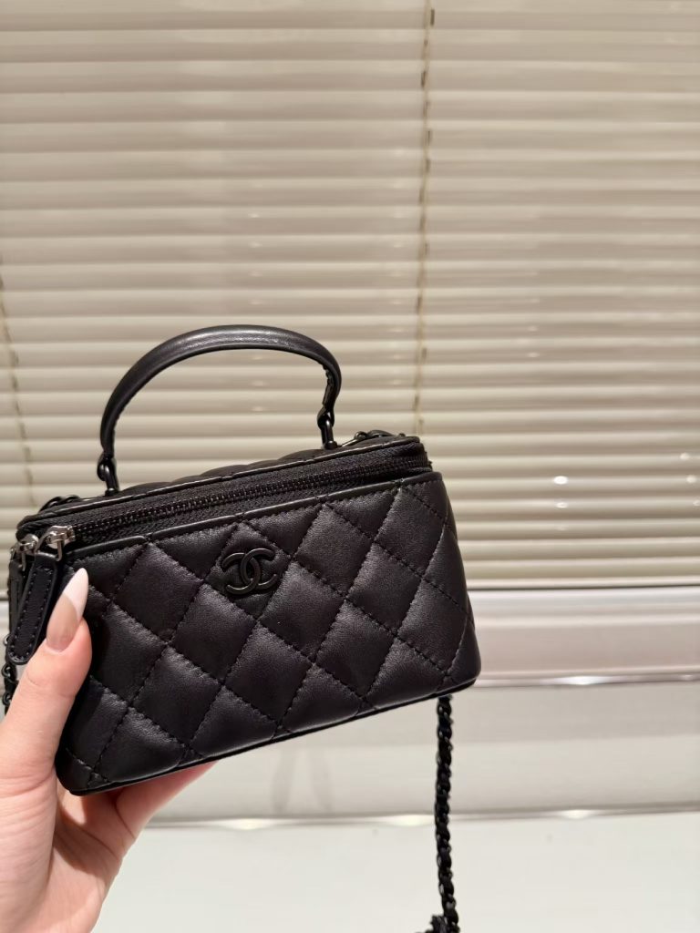 Chanel Classic Lambskin Vanity Bag with Top Handle in black leather, featuring black hardware and iconic Chanel CC logo.