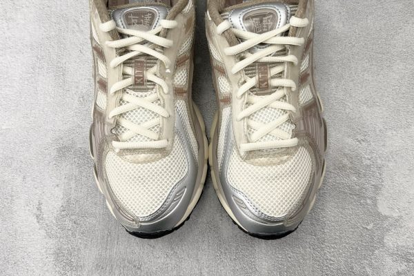 ASICS × KITH GEL-Kayano 12.1 top view displaying Chinese character tongue patch and KITH lace tag detail