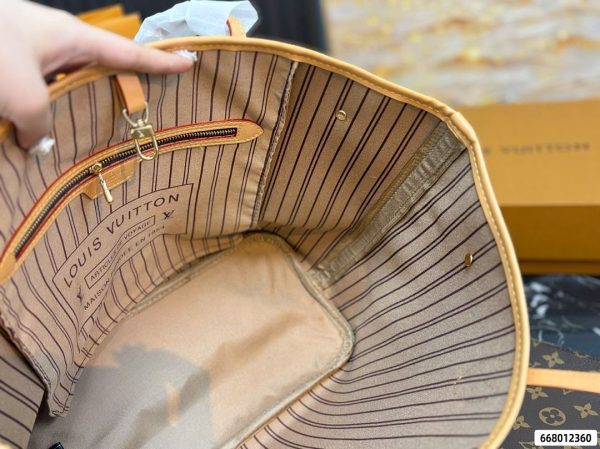 Interior of Louis Vuitton Neverfull MM tote with striped lining and zipped pocket