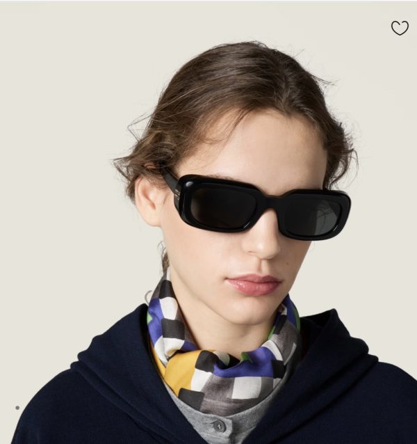 Model wearing Miu Miu black rectangle sunglasses with checkered scarf
