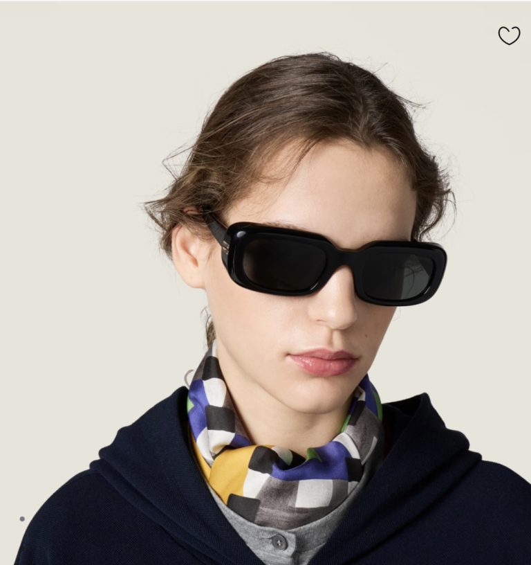 Model wearing Miu Miu black rectangle sunglasses with checkered scarf