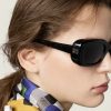 Model wearing Miu Miu black rectangle sunglasses with checkered scarf