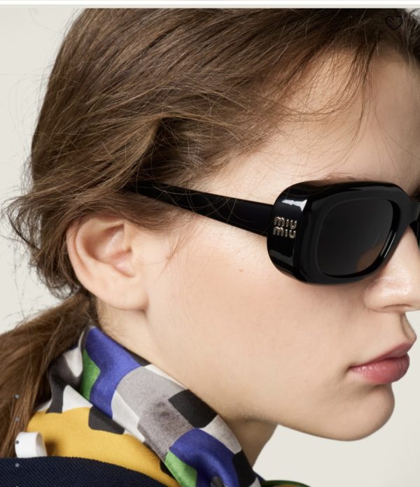 Model wearing Miu Miu black rectangle sunglasses with checkered scarf